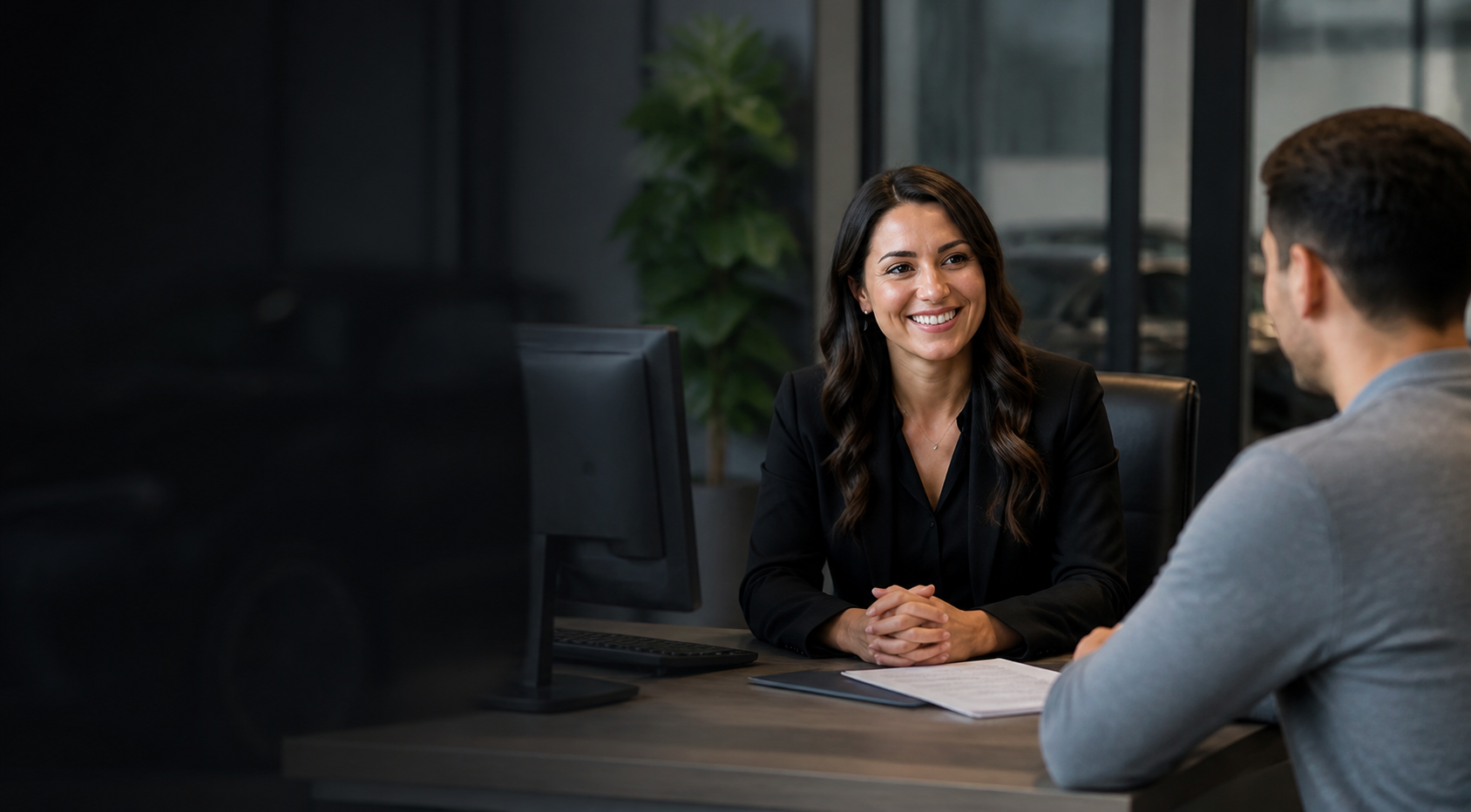 Finance specialist listening to a customer at a dealership